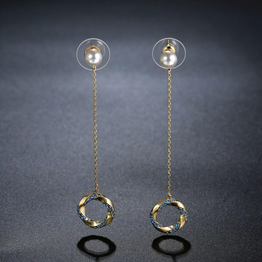 KHAISTA blue CZ pearl dangle earrings on white background