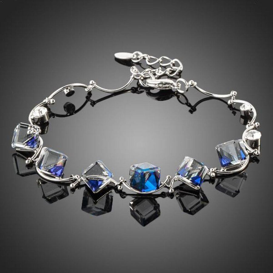 KHAISTA blue square crystal charm bracelet on white background