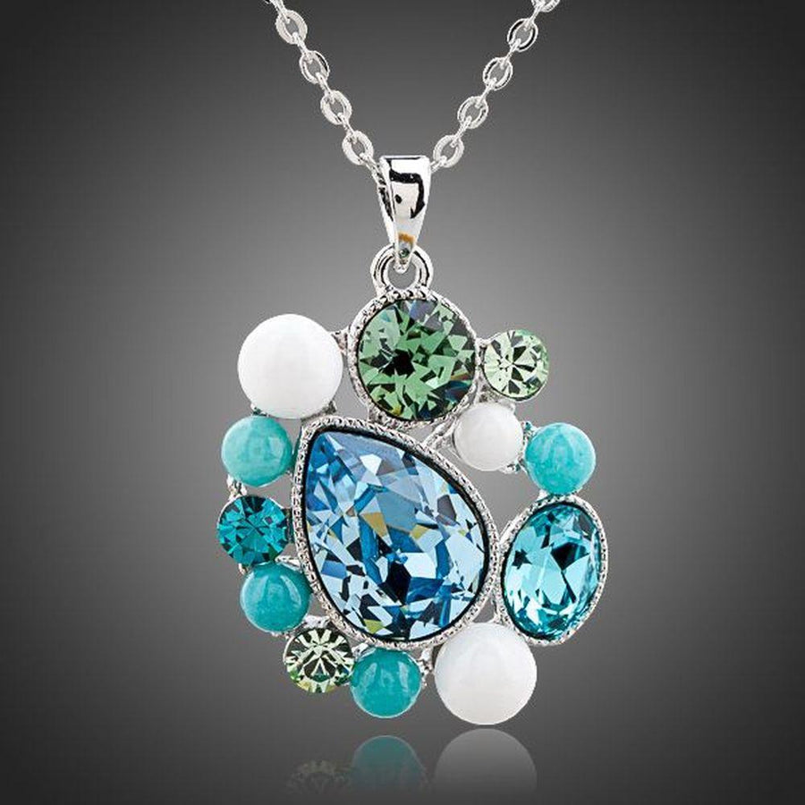 KHAISTA blue teardrop Stellux Austrian crystal necklace on white background
