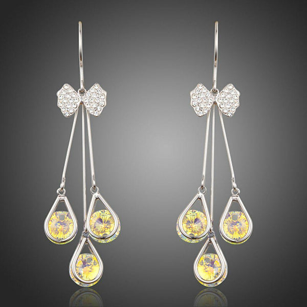 KHAISTA bow knot crystal drop hoop earrings on white background