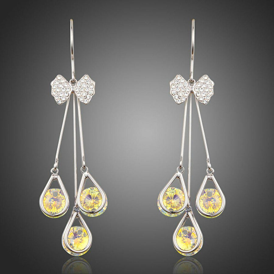 KHAISTA bow knot crystal drop hoop earrings on white background