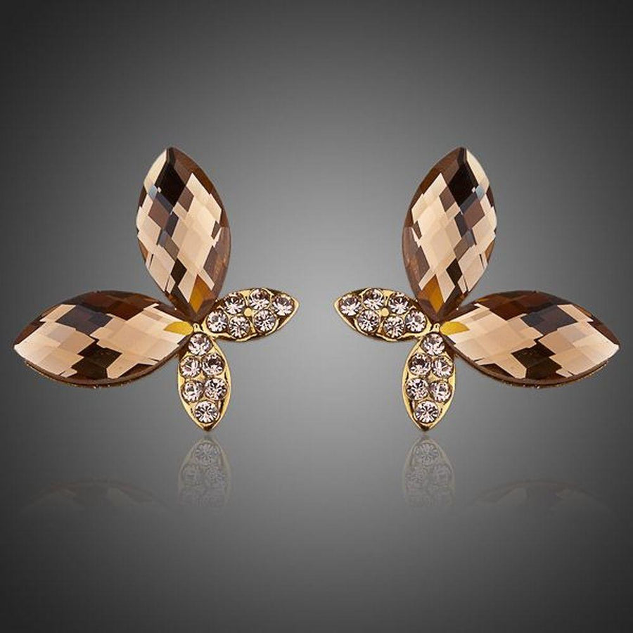 KHAISTA gold Stellux butterfly stud earrings on white background