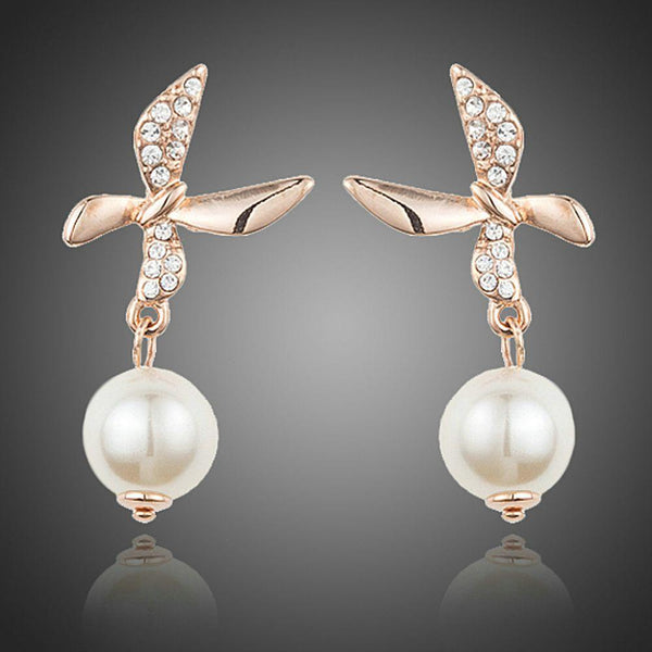 KHAISTA butterfly pearl drop earrings on white background