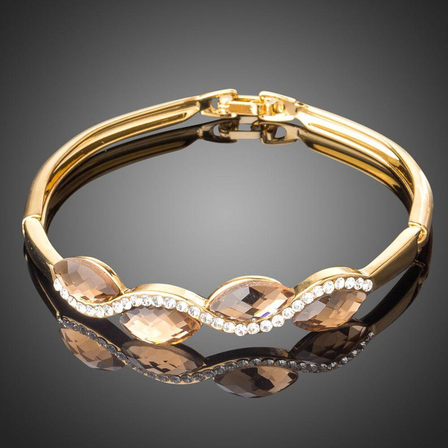 KHAISTA caramel crystal wave bangle on white background