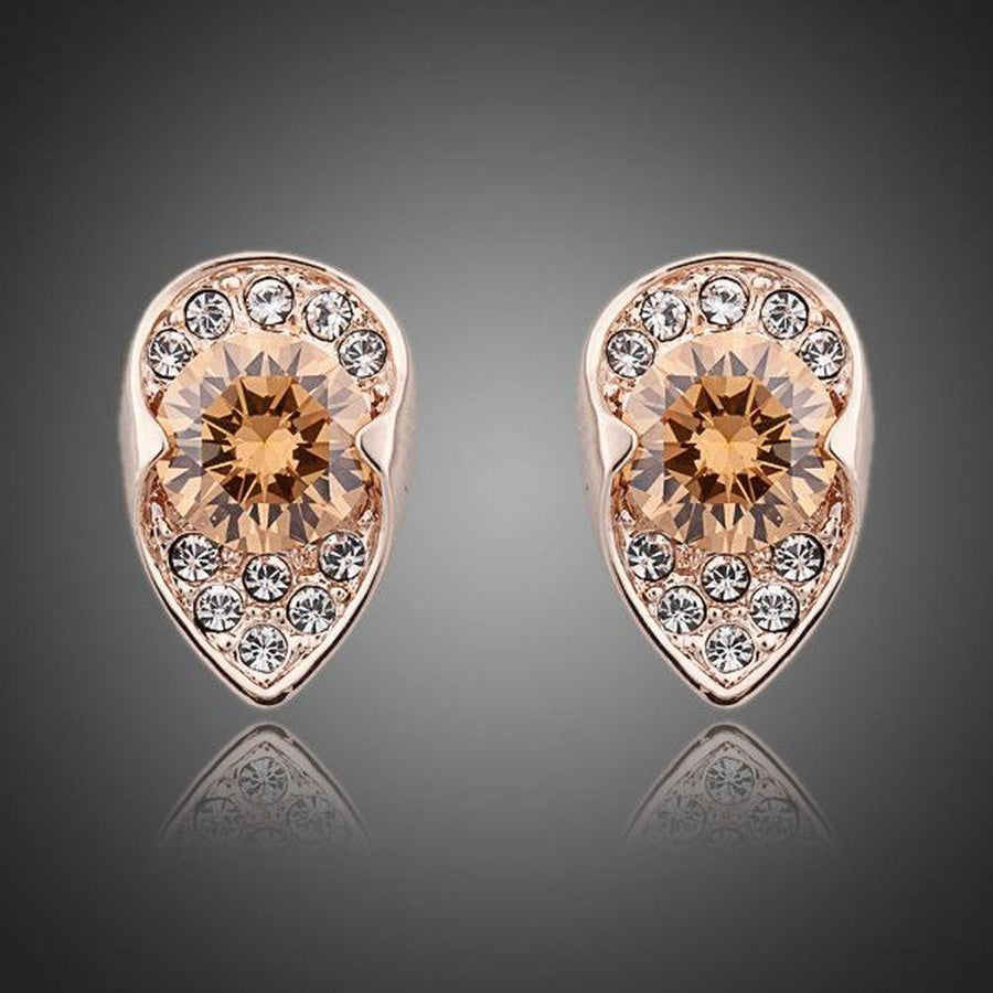 KHAISTA champagne CZ stud earrings on white background