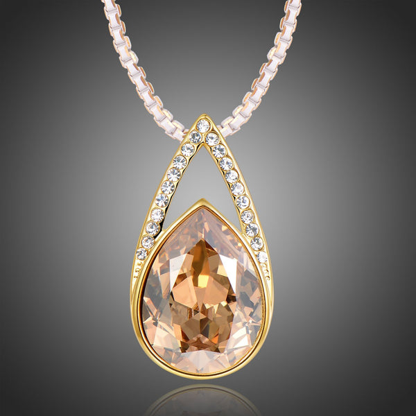 KHAISTA champagne pear shape crystal necklace on white background