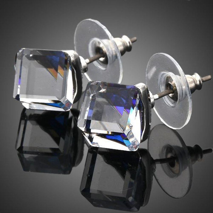 KHAISTA crystal blue square stud earrings on white background