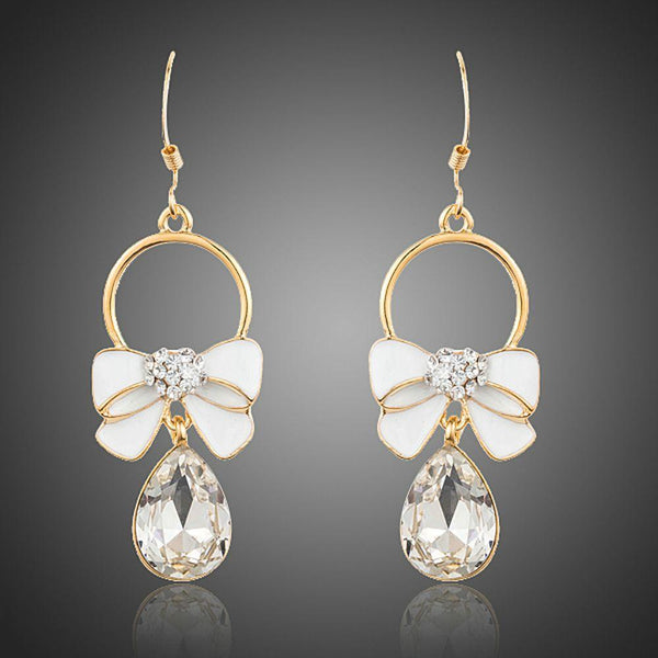 KHAISTA crystal bow knot drop earrings on white background