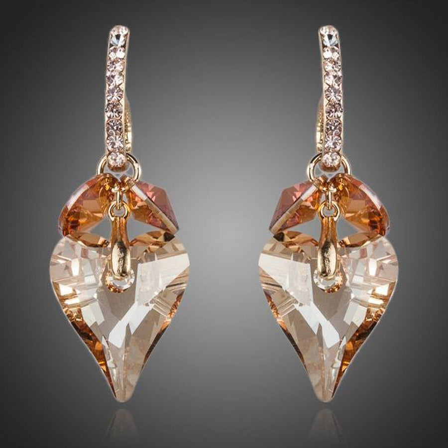 KHAISTA caramel crystal heart drop earrings on white background