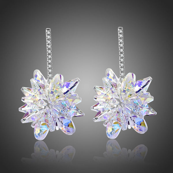 KHAISTA crystal dangle earrings on white background