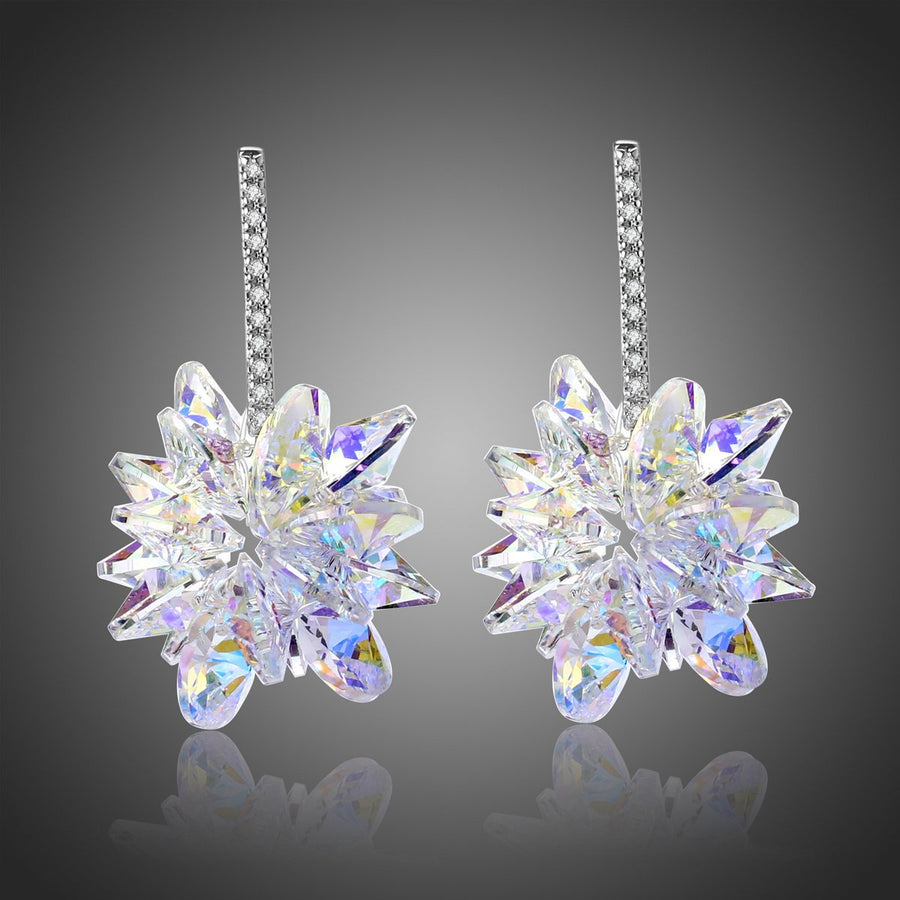 KHAISTA crystal dangle earrings on white background