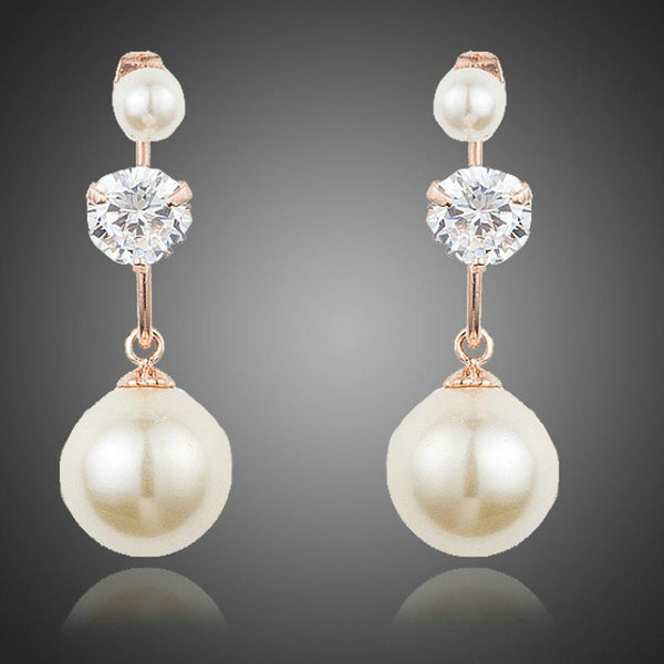 KHAISTA CZ pearl drop earrings on white background
