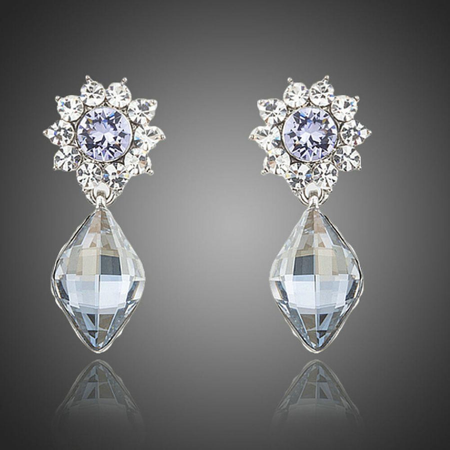 KHAISTA dangling crystal drop earrings on white background