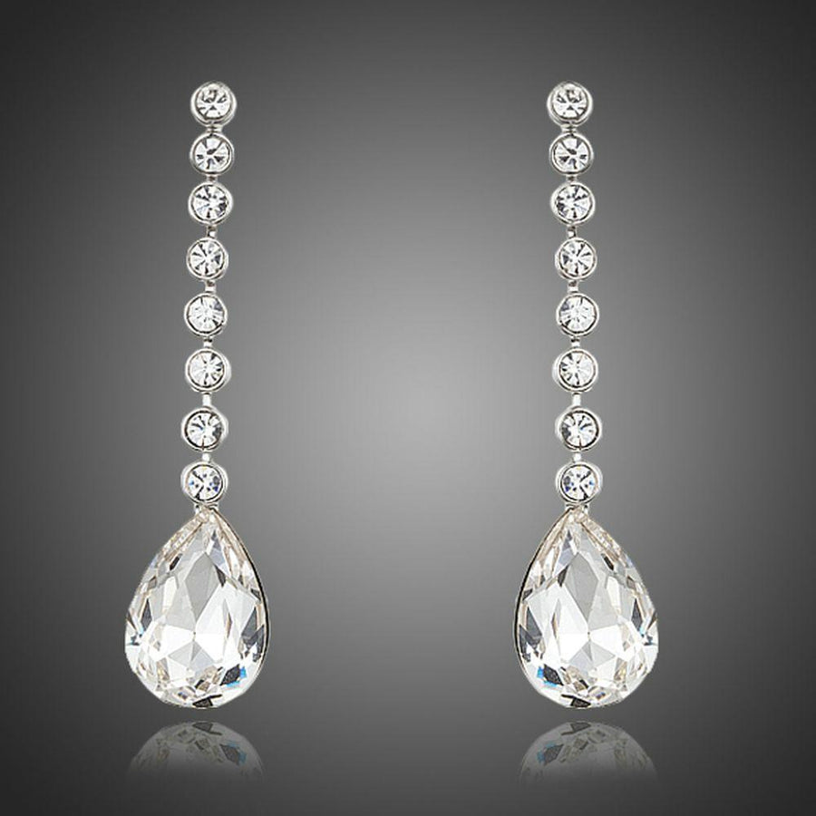 KHAISTA dangling crystal water drop earrings on white background