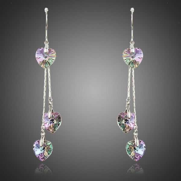 KHAISTA dangling heart crystal drop earrings on white background