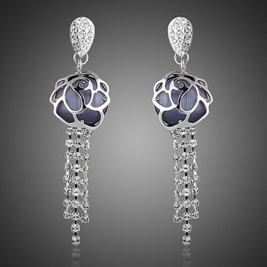 KHAISTA flower crystal tassel drop earrings on white background