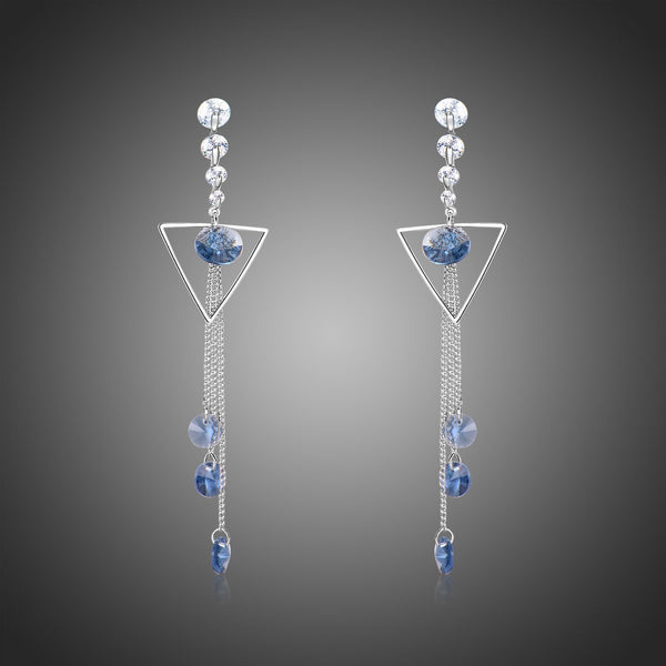 KHAISTA geometric blue crystal long drop earrings on white background