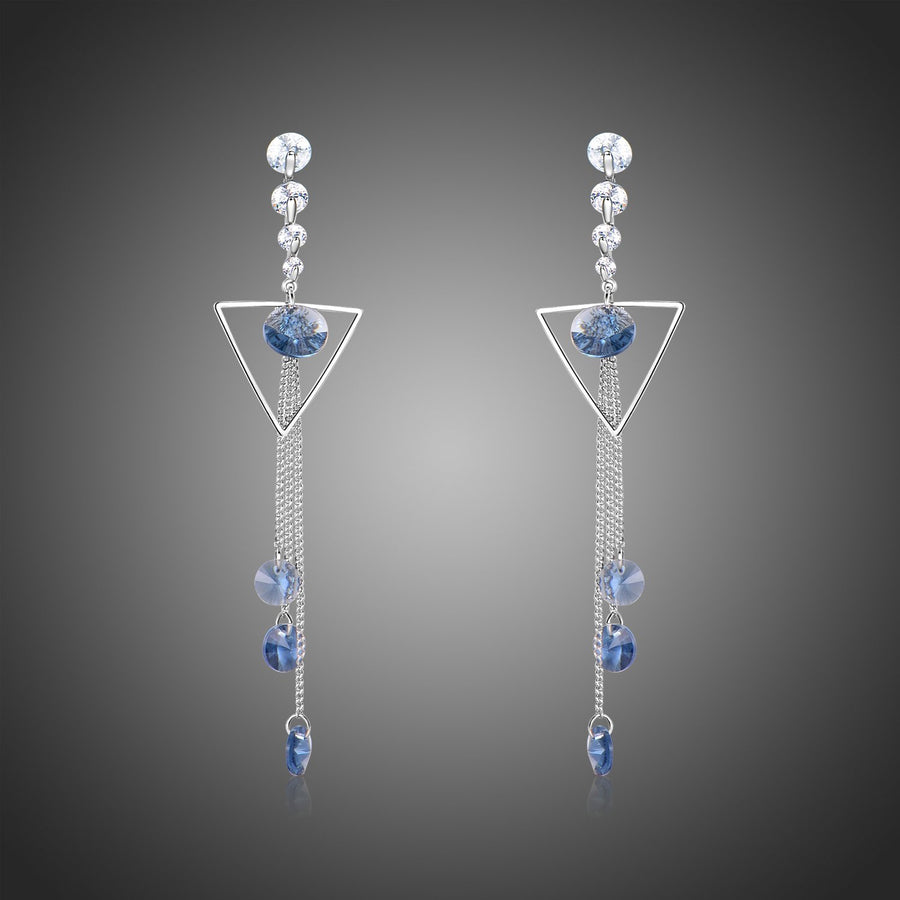 KHAISTA geometric blue crystal long drop earrings on white background