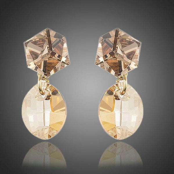 KHAISTA geometric crystal drop earrings on white background