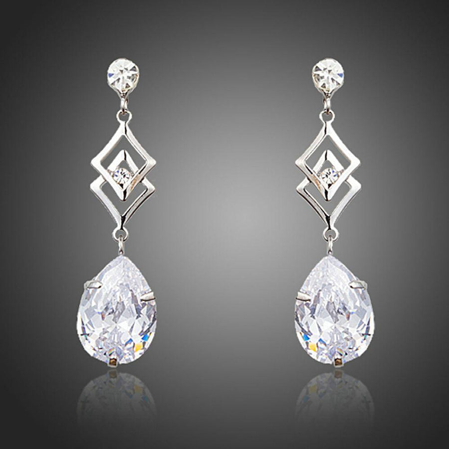 KHAISTA geometric CZ earrings on white background
