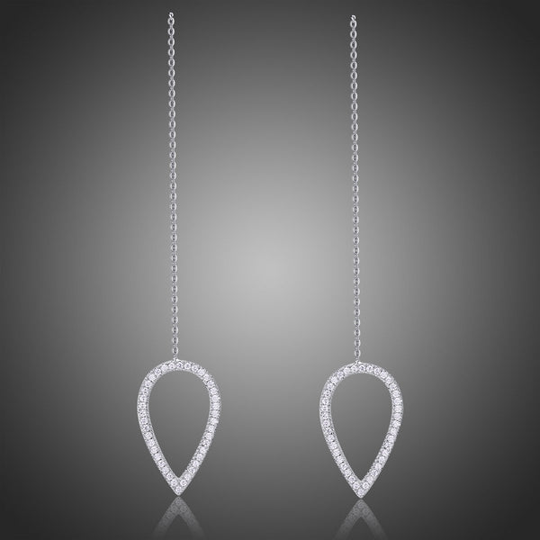 KHAISTA geometric long drop earrings on white background