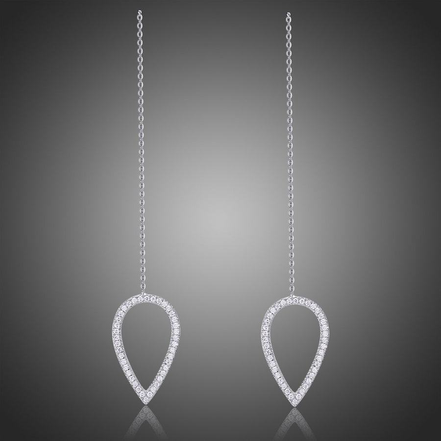 KHAISTA geometric long drop earrings on white background