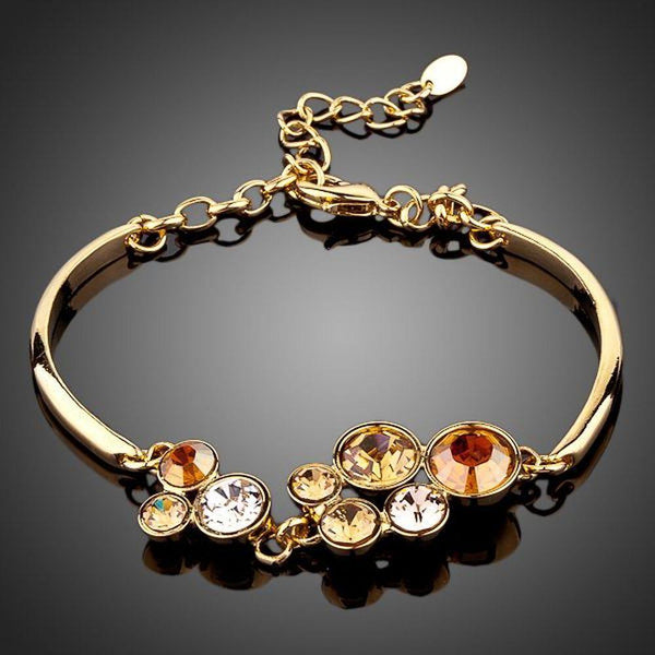 KHAISTA gold plated crystal cluster bracelet on white background