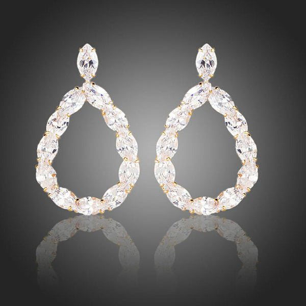 KHAISTA gold plated CZ chain drop earrings on white background