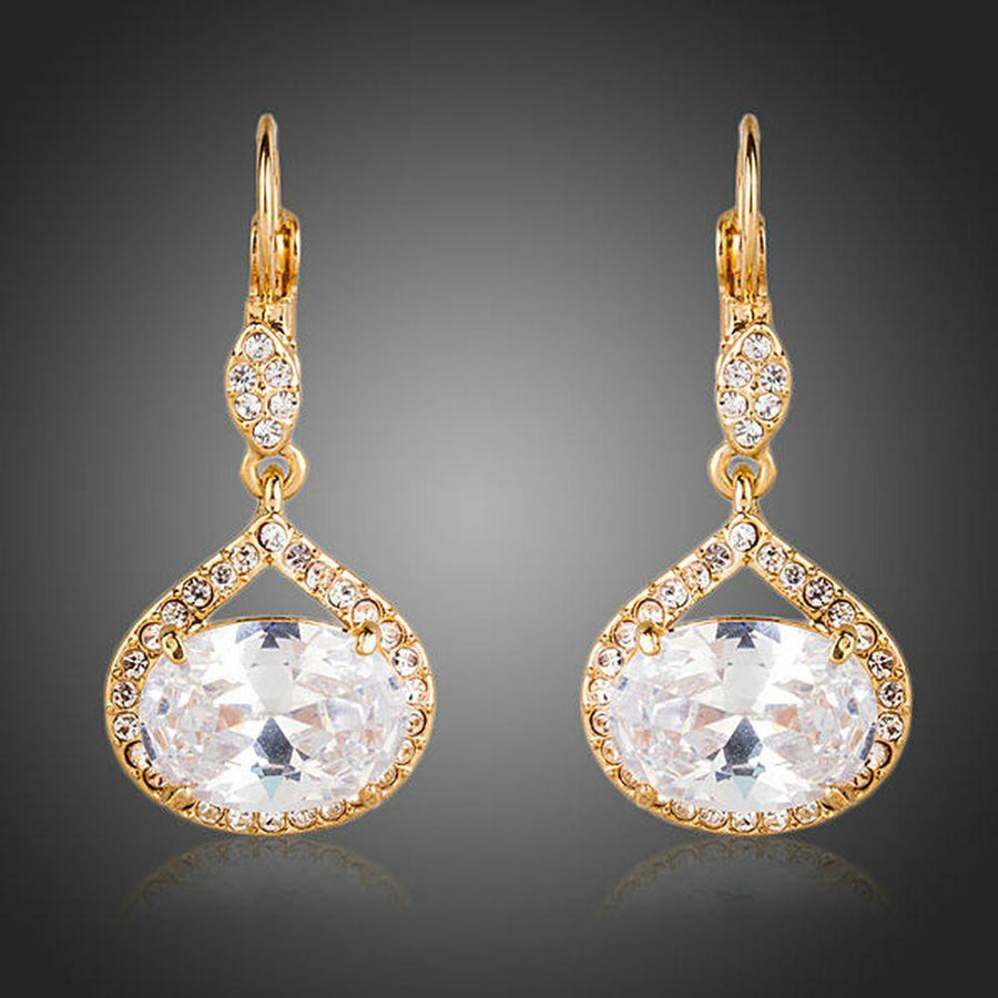 KHAISTA gold plated CZ love drop earrings on white background