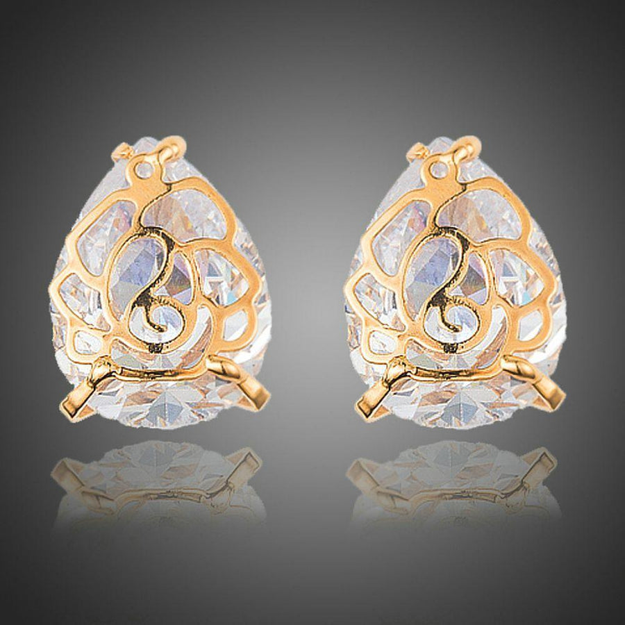 KHAISTA gold plated flower shaped CZ earrings on white background