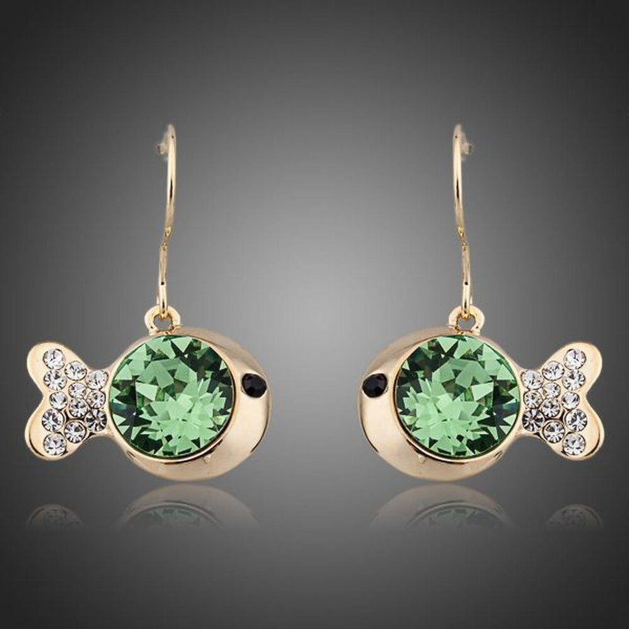 KHAISTA gold plated green crystal fish drop earrings on white background
