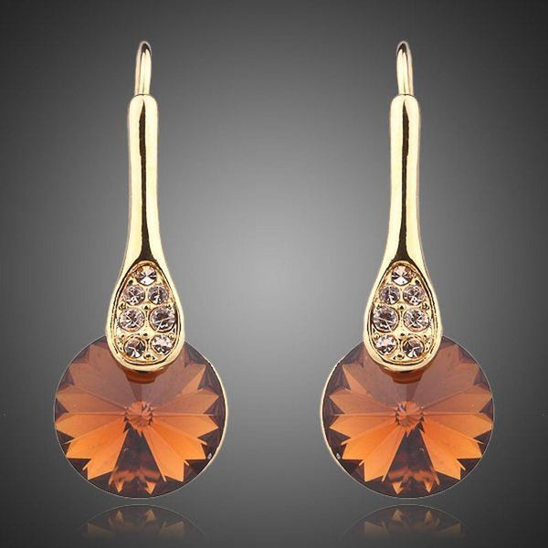 KHAISTA gold plated maple leaf design drop earrings on white background