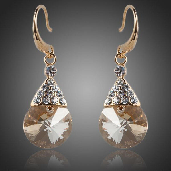 KHAISTA gold plated raindrop crystal drop earrings on white background