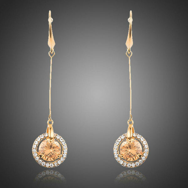 KHAISTA golden CZ drop earrings on white background