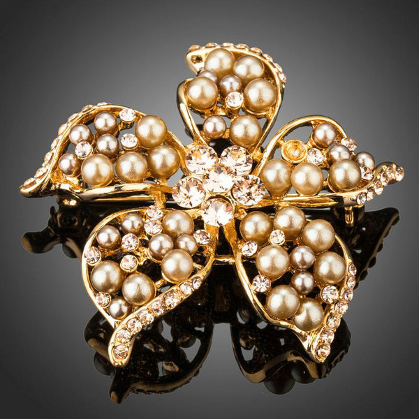 Khaista gold pearl flower brooch pin on white background