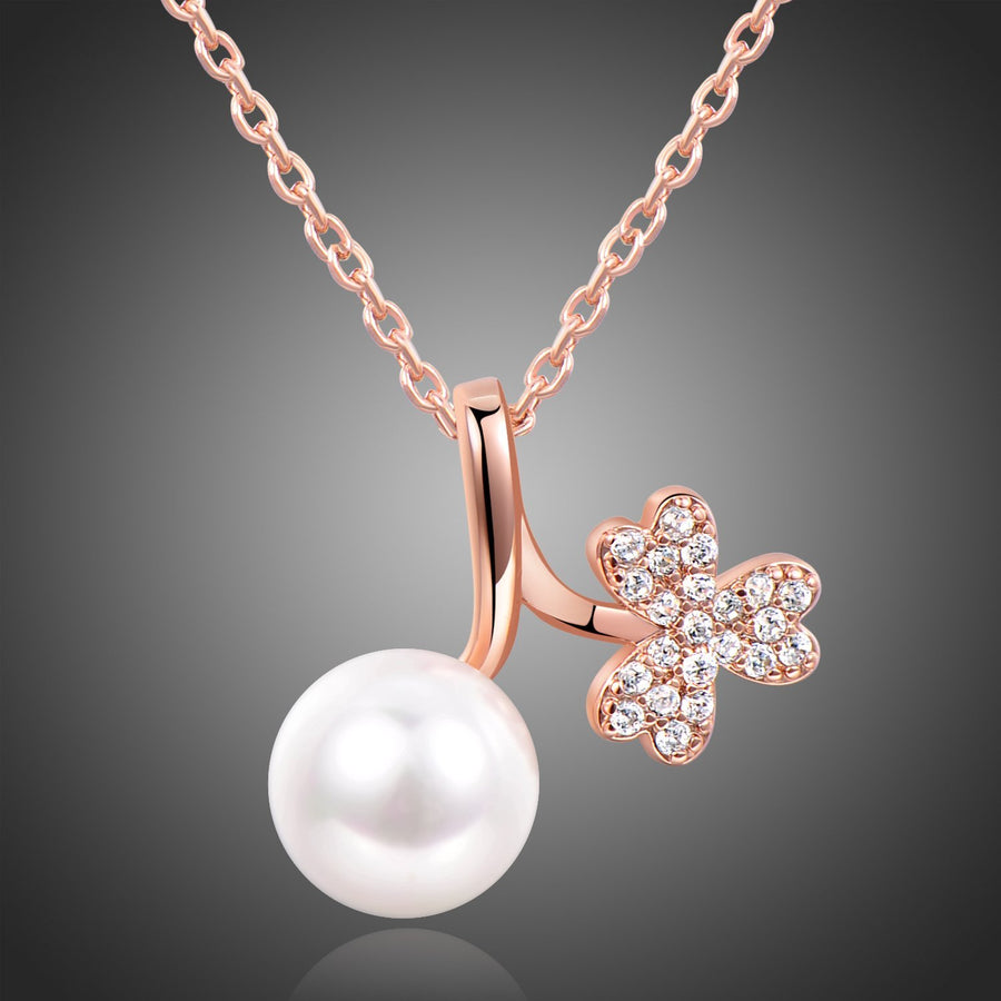 KHAISTA gold pearl pendant necklace on white background
