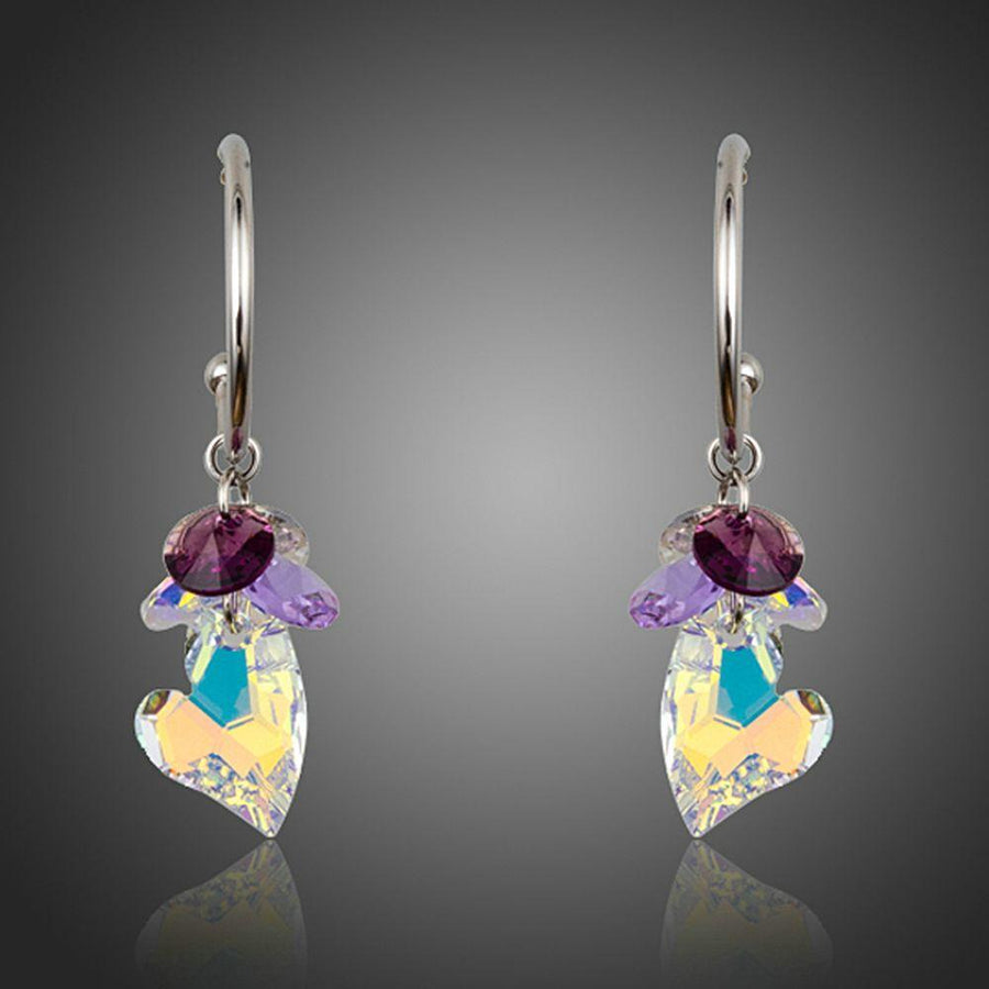 KHAISTA heart charm crystal drop earrings on white background