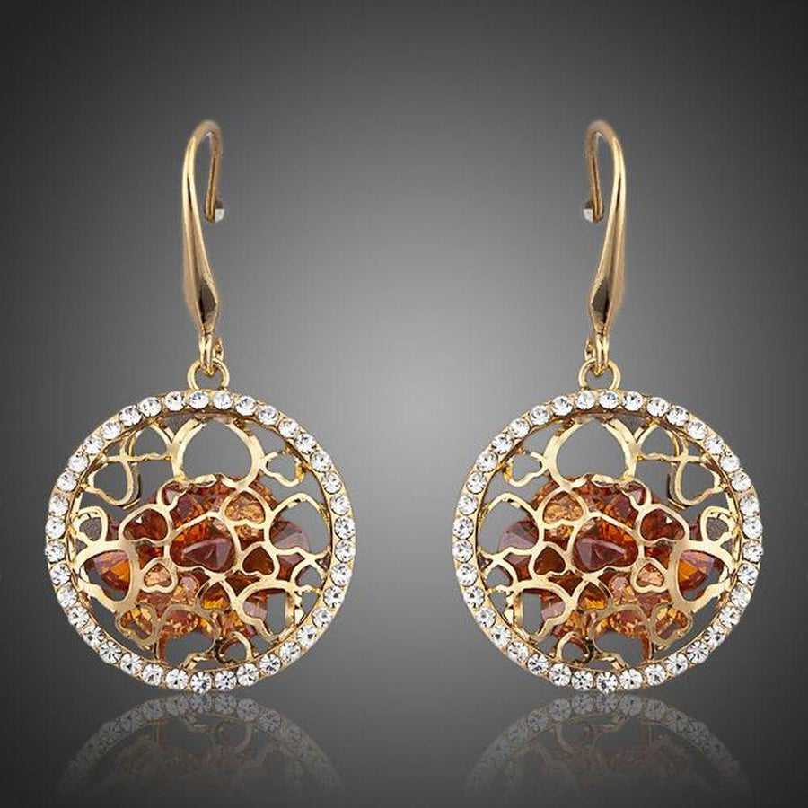 KHAISTA irregular gold CZ drop earrings on white background