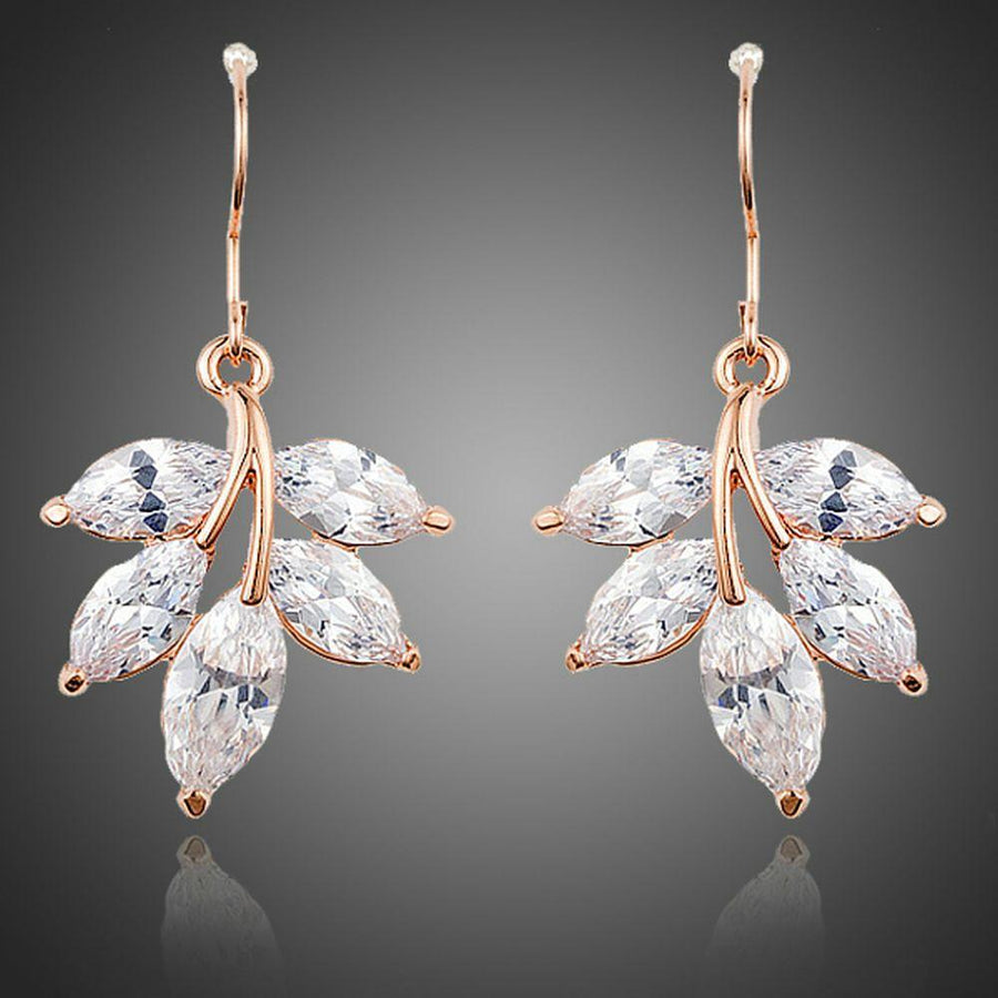 KHAISTA leaf shaped zircon drop earrings on white background