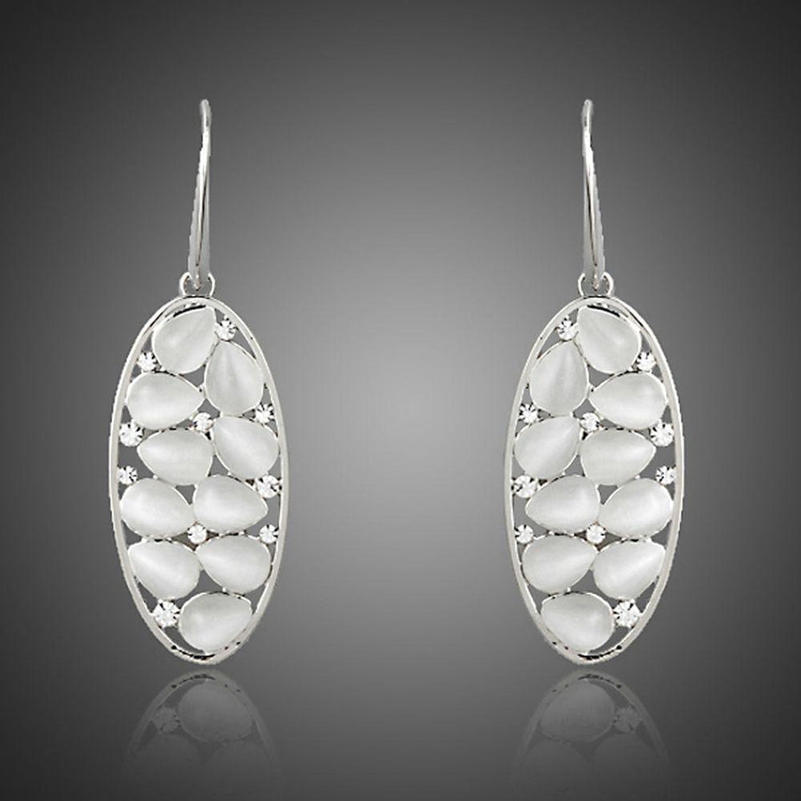 KHAISTA light grey crystal oval drop earrings on white background