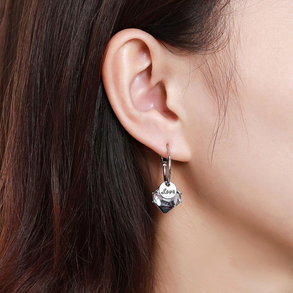 KHAISTA love crystal drop earrings on white background