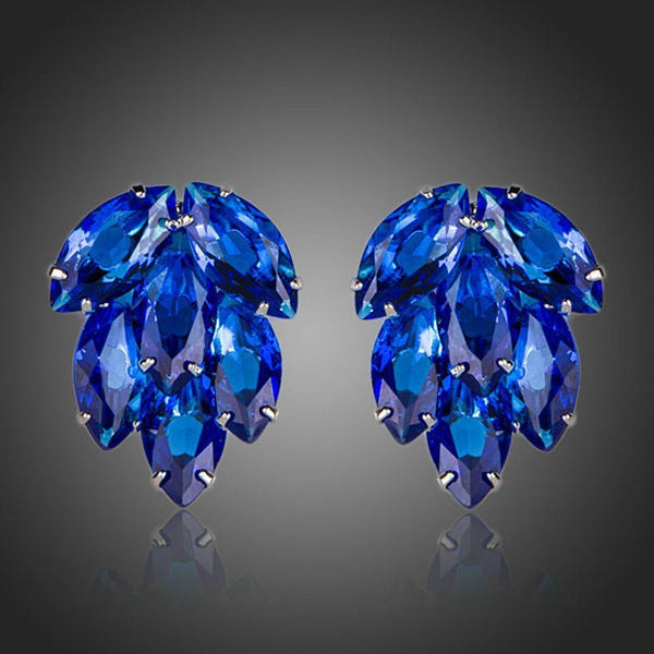 KHAISTA ocean blue CZ stud earrings on white background