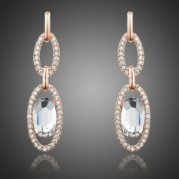 KHAISTA oval chain link crystal drop earrings on white background