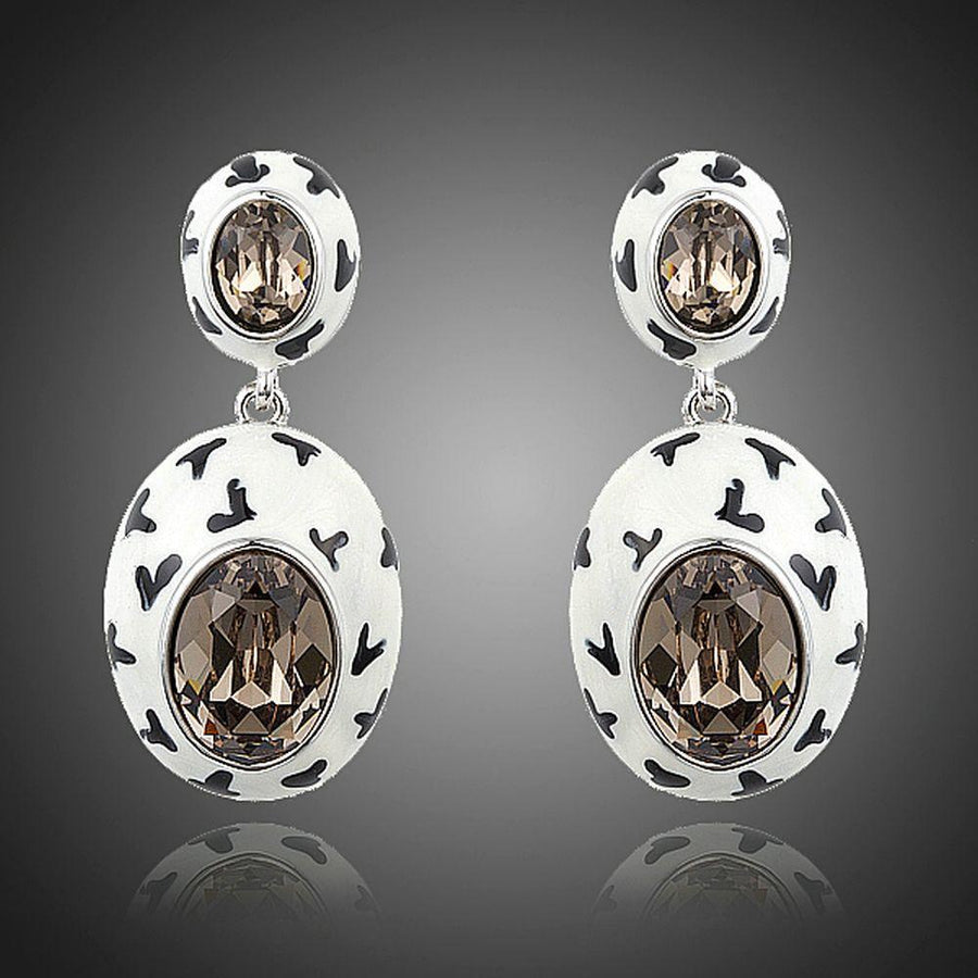 KHAISTA oval crystal pave drop earrings on white background