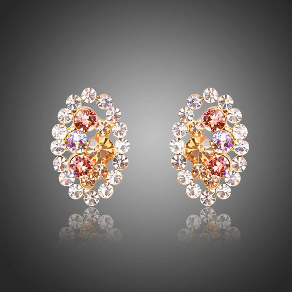 KHAISTA oval flower stud earrings on white background