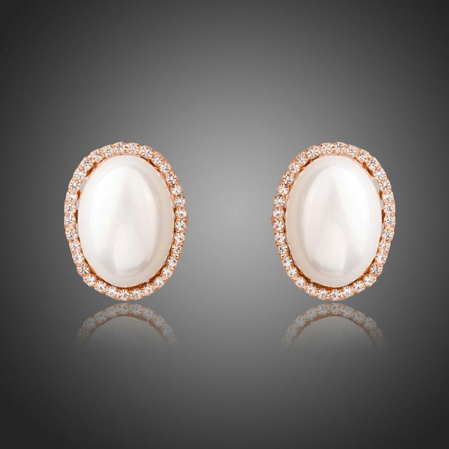 KHAISTA oval shell pearl stud earrings on white background