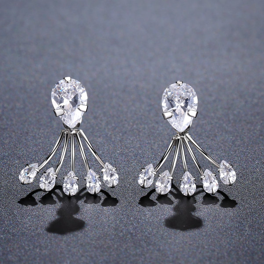 KHAISTA crystal paw design drop earrings on white background