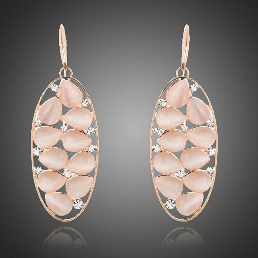 KHAISTA peach crystal oval drop earrings on white background