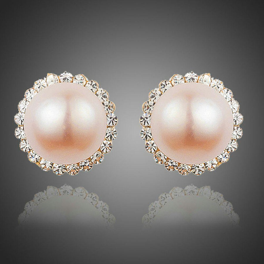 KHAISTA peach pearl dome stud earrings on white background