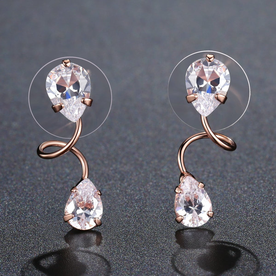 KHAISTA pear cut CZ drop earrings on white background